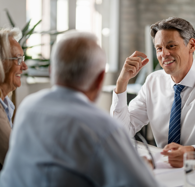 Lawyers talking with elderly couple